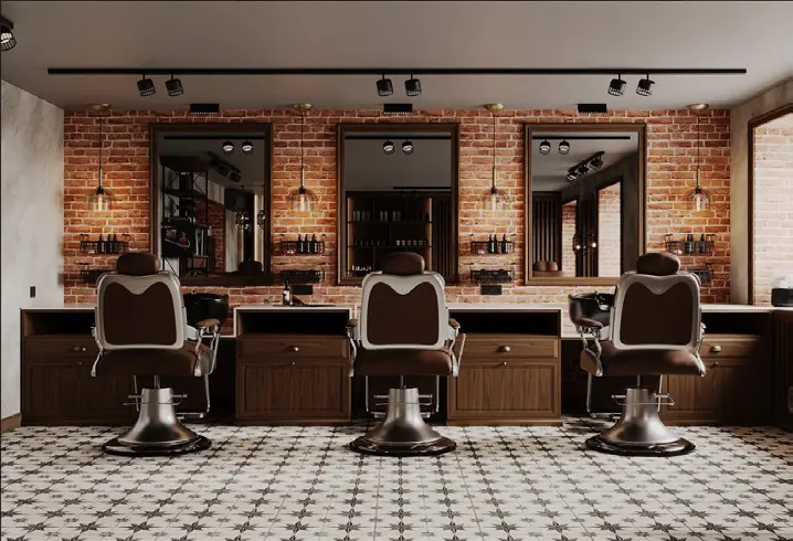 A salon interior with leather styling chairs, mirrors and exposed brick